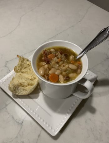 Finished ham and bean soup with a dinner roll