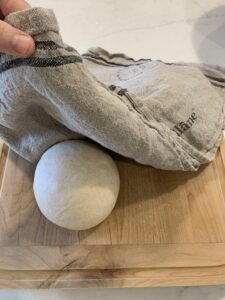 covering preshaped loaves with a towel to rest