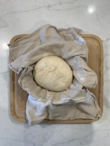 Placing the final shaped round boule in a banneton