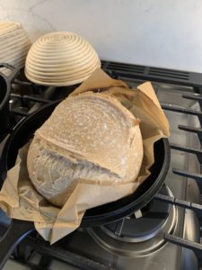 Uncovering the round loaf half way through baking