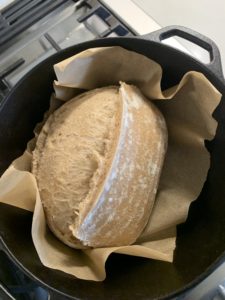 Uncovering the oval loaf half way through baking